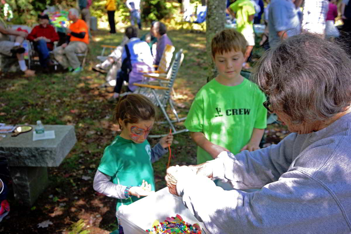 two boys in green shirts at crafts table at springdale mill celebration