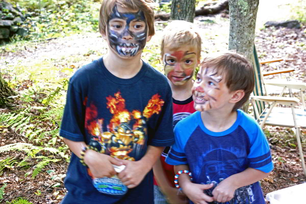 three boys with faces painted