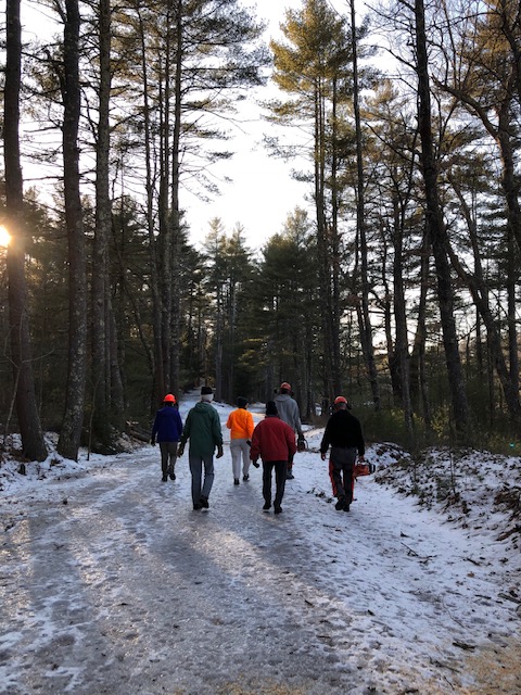 people walking down snowy rail trail