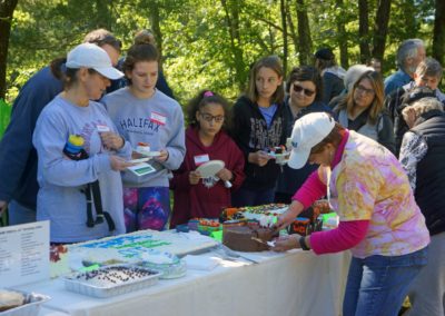 image of volunteer cutting and serving birthday cakes