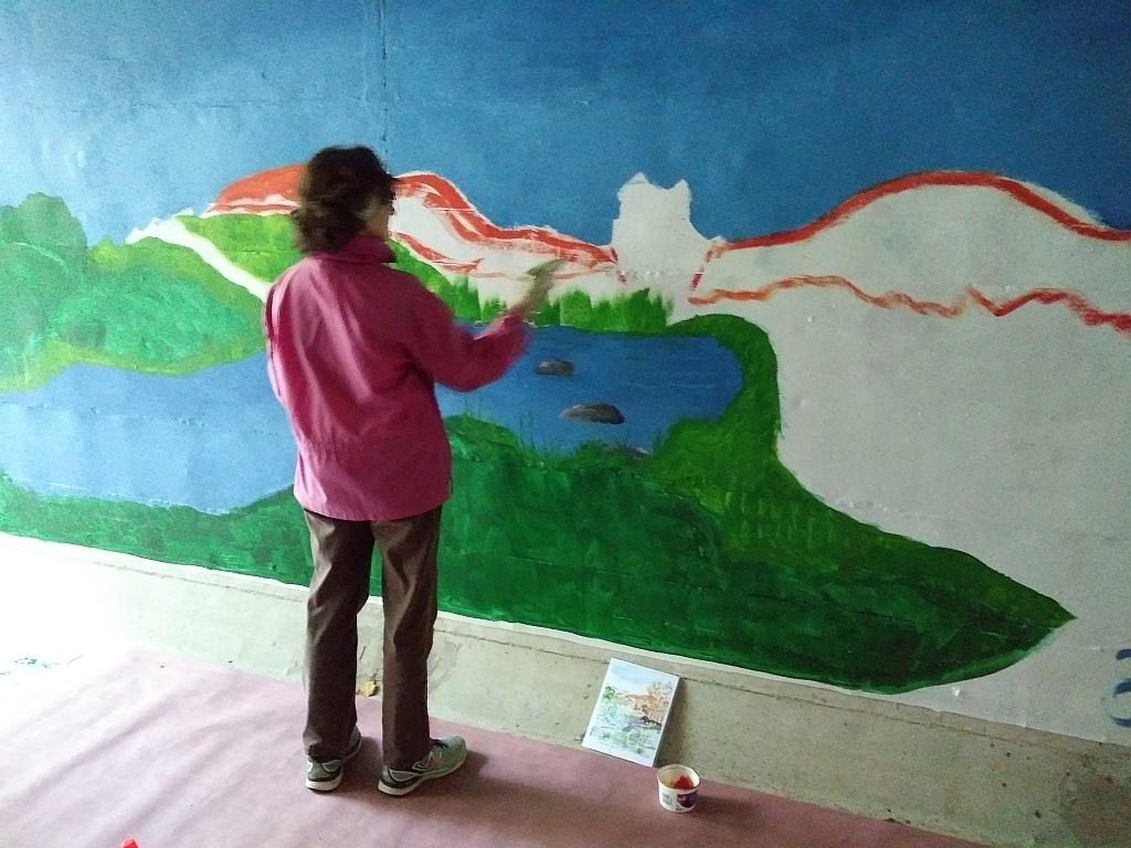 Elsie Uffelmann from Worcester painting mural in charnock hill tunnel on MCRT in Rutland